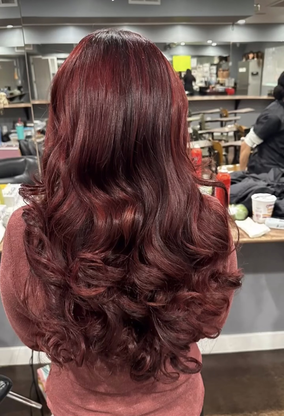 Cherry red hair color with voluminous curled layers