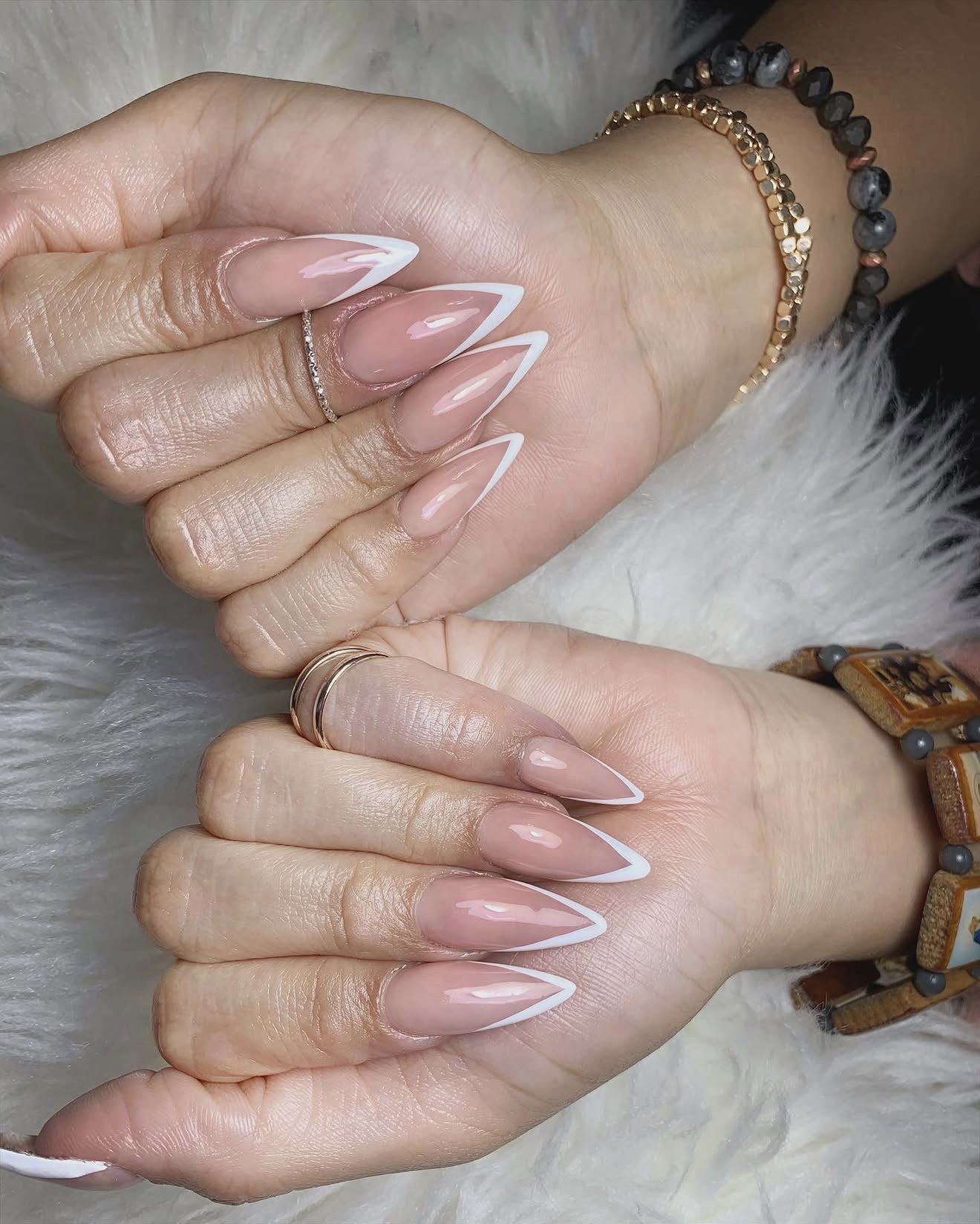 Nude stiletto nails with crisp white French tips