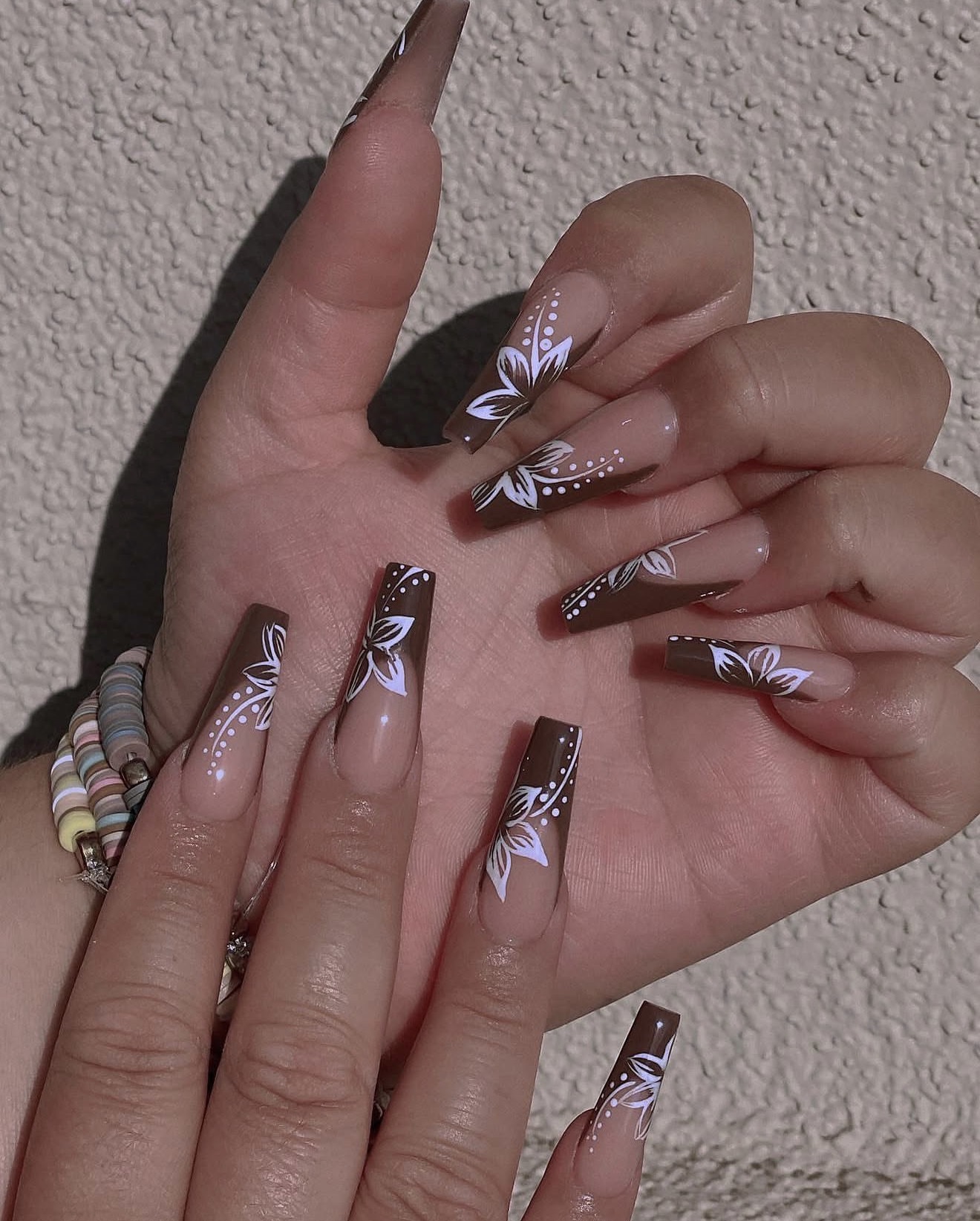 Mocha coffin nails with hand-painted white floral art