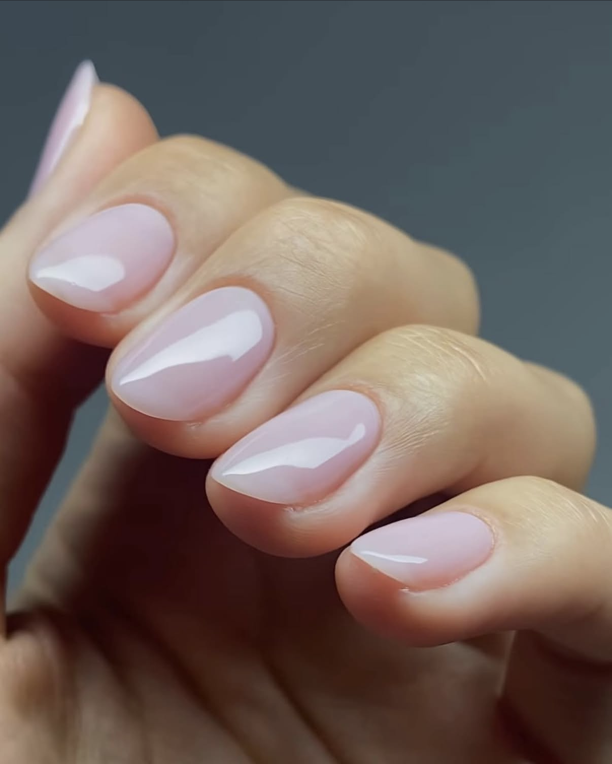 Glossy pink almond nails with a natural sheer finish