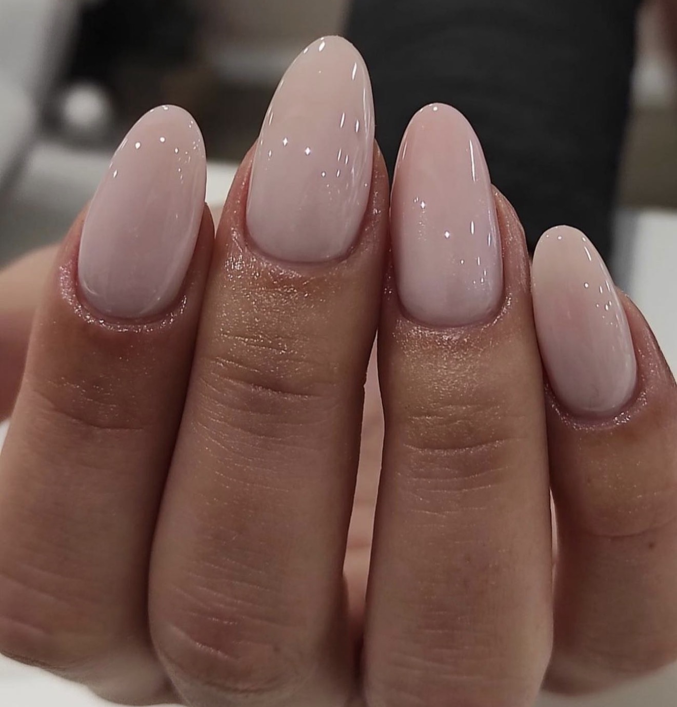 Milky pink almond nails with glossy finish